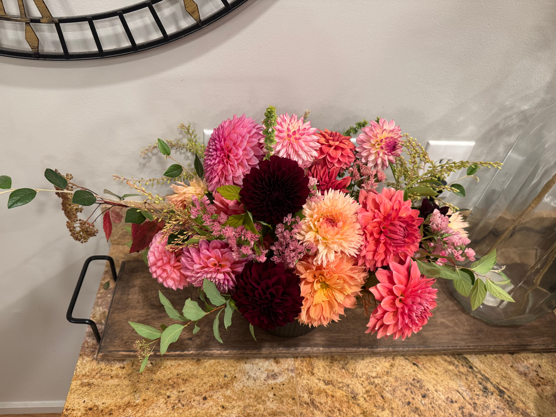 Vibrant pink, peach, and burgundy dahlia arrangement